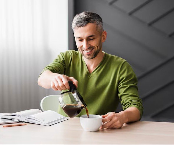 Ravi, head chai maker, pouring chai from a height